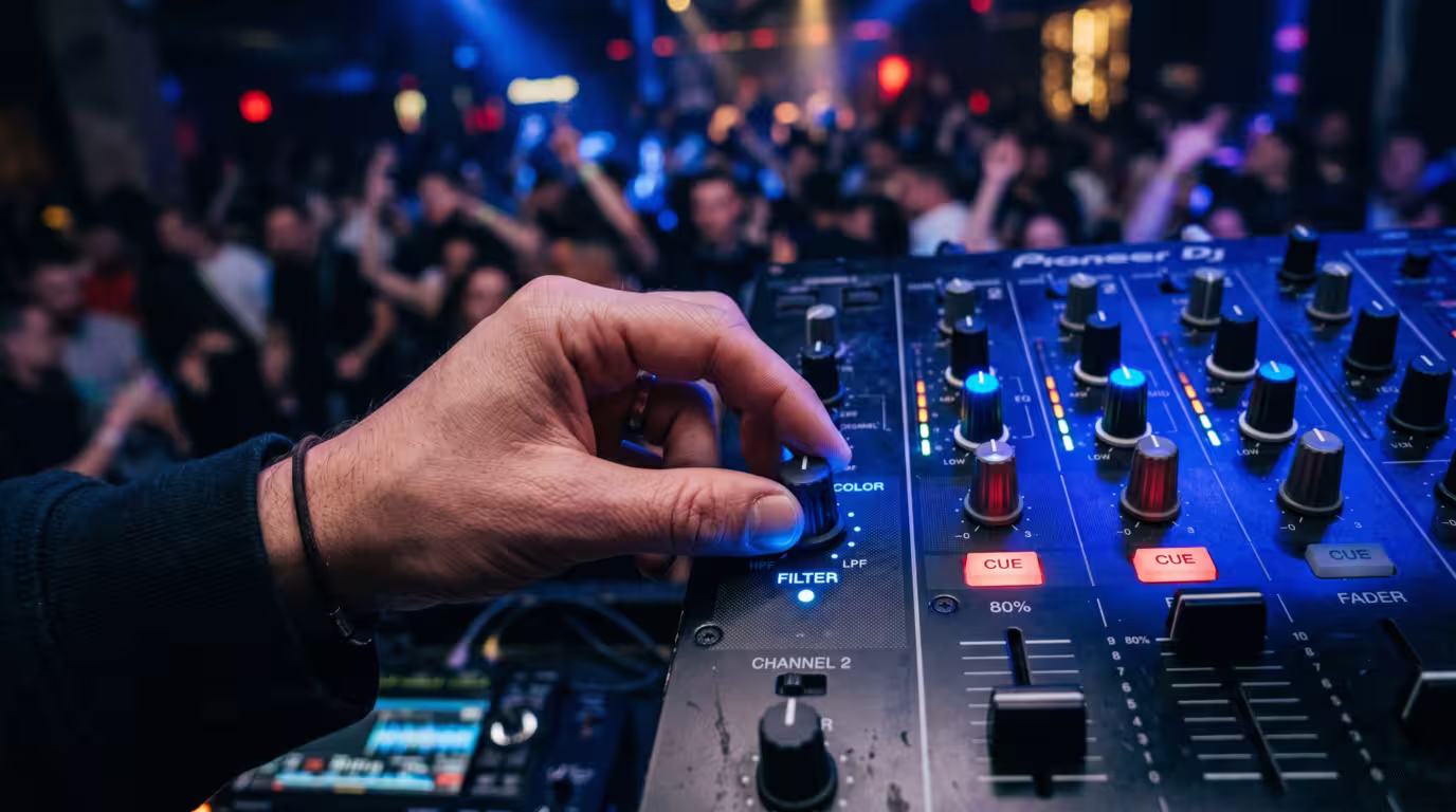 A DJ turning the filter knob during a filter-sweep transition